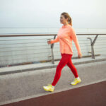 Charming sporty lady having race walking training outdoors stock photo